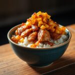 A delicious Street Corn Chicken Rice Bowl topped with grilled corn, seasoned chicken, fresh herbs, and a creamy sauce.